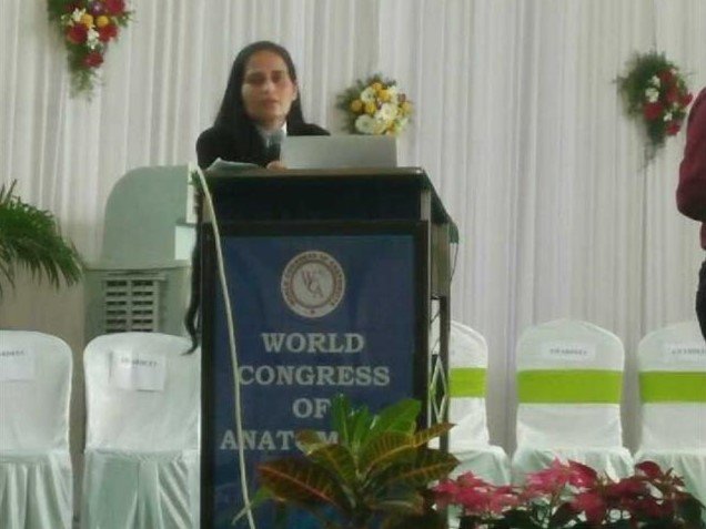 Dr Krupa Torne speaking on stage at a medical conference
